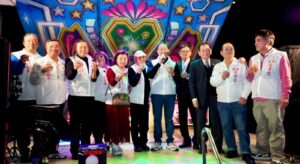 圖說：管委會團隊合影 艋舺二水門龍津宮管理委員會全體成員於晚宴舞台上合影留念。眾人身著統一隊服舉杯，向現場參與的信眾及貴賓致意，感謝各界過去一年來對宮務的熱情護持。(圖／主辦單位提供)